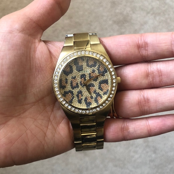 Gold Guess watch with leopard background